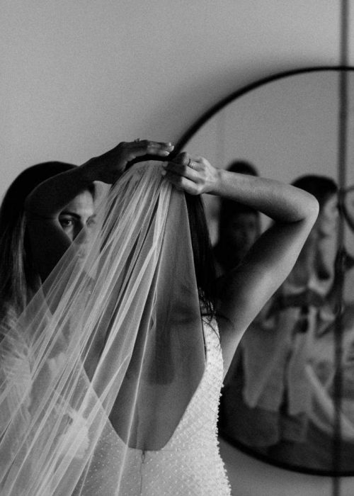 bride adjusting her wedding veil