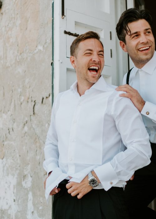 groom and best man laugh together