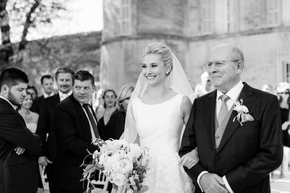 father of the bride escorts his daughter to the altar