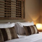 chic bedroom with boho style bed cushions at terra rosa country house and vineyards wedding venue in portugal