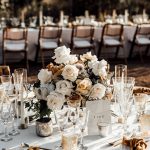 the outdoor wedding breakfast set up with beautiful seasonal flowers in muted autumnal tones at ibiza wedding venue ca na xica in ibiza