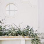 outdoor wedding ceremony set up with foliage and two white wooden chairs at wedding venue casa sacoto in portugal