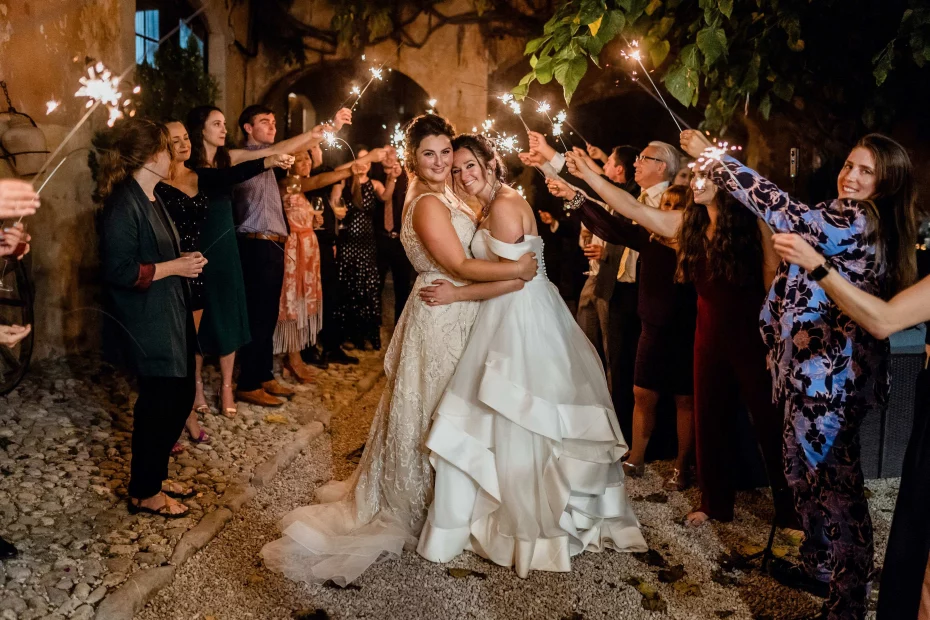brides surrounded by family and sparklers outside at villa catalina