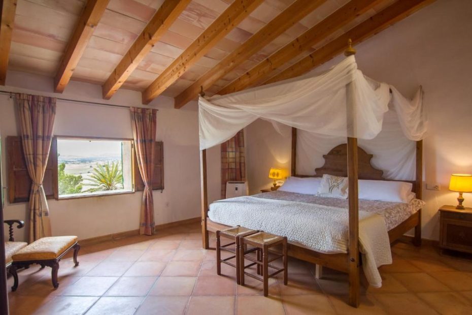 bedroom with tiled floor and view out over surrounding farmland at wedding venue in mallorca san son Andreau