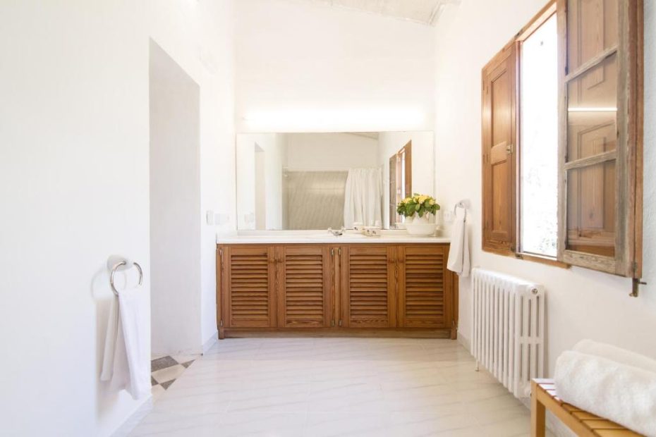 chic simple bathroom with wooden sink unit at wedding venue in mallorca san son Andreau