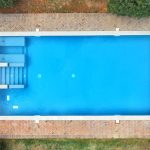 view directly above the rectangular blue outdoor swimming pool at Italian wedding venue Castello di San Fabiano