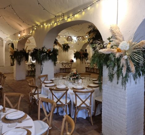 wedding reception tables with wooden rustic chairs at villa Catalina in spain