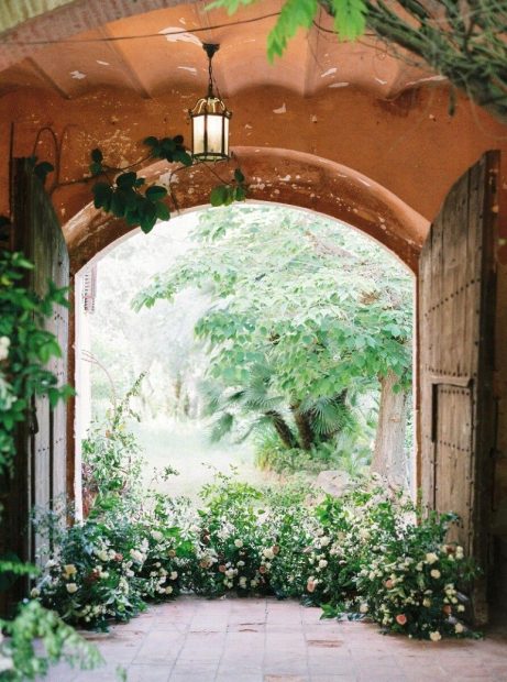 wooden doorway with floral floor arrangement at spanish wedding villa