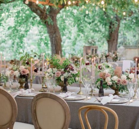Al fresco dining tables with different styles of chairs at spanish wedding venue