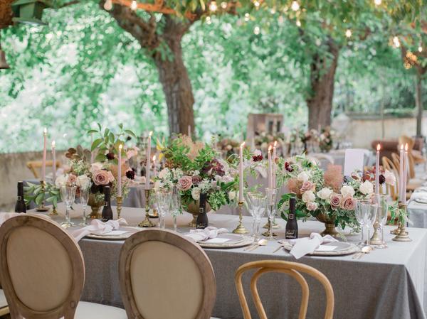 Al fresco dining tables with different styles of chairs at spanish wedding venue