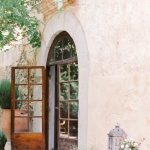 Arched wooden glass door entryway at rustic spanish wedding venue Villa Catalina