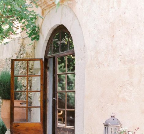 Arched wooden glass door entryway at rustic spanish wedding venue Villa Catalina