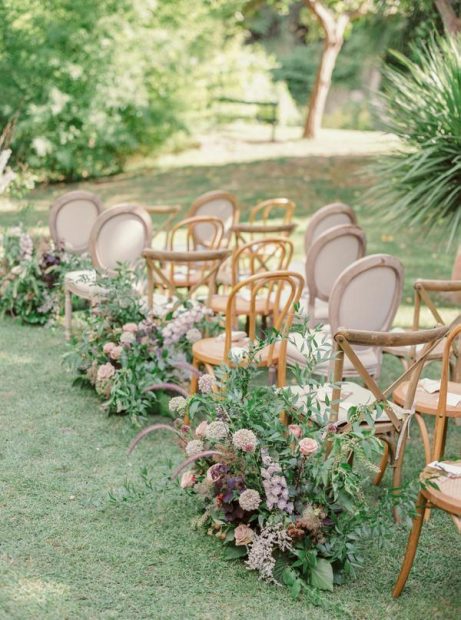 ceremony aisle on the lawn with neutral florals lining the aisle at spanish wedding venue Villa Catalina