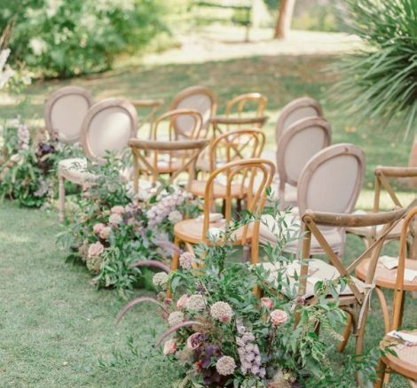 ceremony aisle on the lawn with neutral florals lining the aisle at spanish wedding venue Villa Catalina