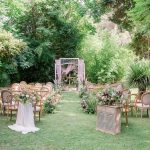 Wedding Ceremony on the grass with an eclectic mix of wooden chairs at rustic spanish wedding venue Villa Catalina