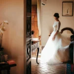 Bride in her wedding dress leaving the bridal suite at Spanish wedding venue villa catalina