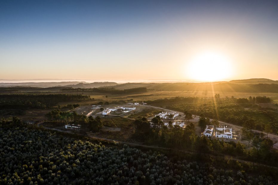 aerial shot just before sundown of craveiral farmhouse in portugal