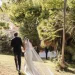bride and groom walking through the grounds of villa catalina
