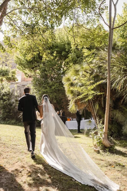 bride and groom walking through the grounds of villa catalina