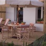 close up shot of exterior decking area with seating at craveiral farmhouse in portugal
