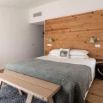 bedroom with minimalistic farmhouse style wooden decor at craveiral farmhouse in portugal