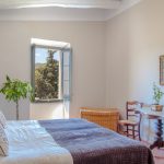 double bedroom with view of the countryside at spanish wedding venue Masia Victoria