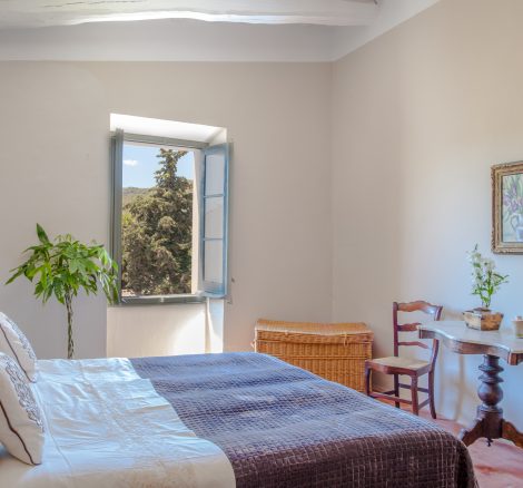 double bedroom with view of the countryside at spanish wedding venue Masia Victoria