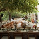 al fresco wedding meal with wooden fold out chairs and beige linen at spanish wedding venue Villa Catalina