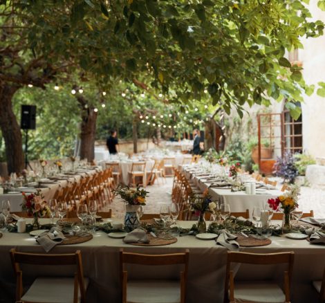 al fresco wedding meal with wooden fold out chairs and beige linen at spanish wedding venue Villa Catalina