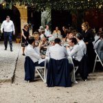 wedding guests sat dining al fresco outside Villa Catalina in Spain
