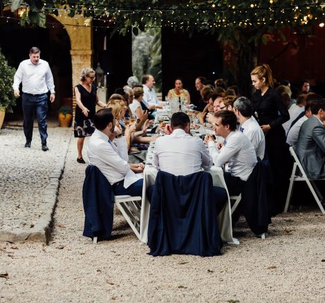 wedding guests sat dining al fresco outside Villa Catalina in Spain