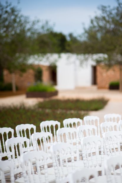 white wedding chairs set up for a wedding at ca na xica wedding venue in ibiza