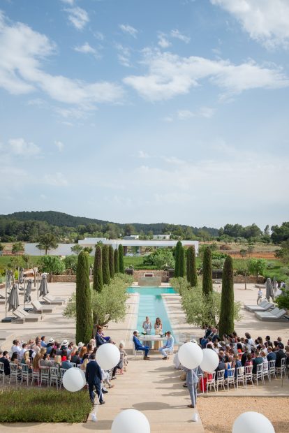 outdoor real wedding ceremony by the t shaped pool at ibiza wedding venue ca na xica