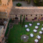 round wedding table laid on the lawn for a wedding at Castello di San Fabiano Italian wedding venue