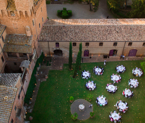 round wedding table laid on the lawn for a wedding at Castello di San Fabiano Italian wedding venue