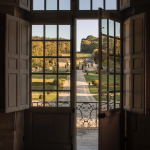 The view out of the French double doors overlooking the manicured gardens at French wedding venue chateau de villete