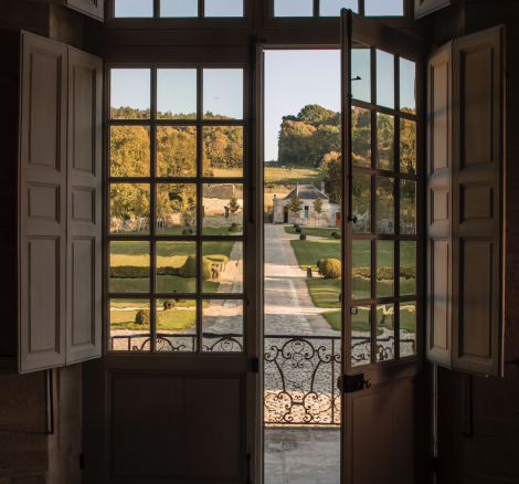 The view out of the French double doors overlooking the manicured gardens at French wedding venue chateau de villete