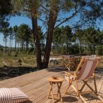 outdoor decking area with deck chairs looking out onto grounds at craveiral farmhouse portugal