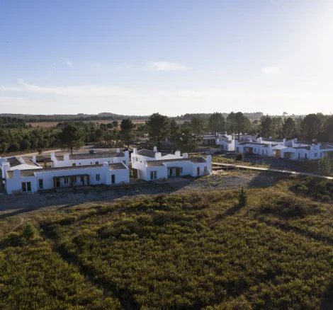 view of the white washed exterior of portugal wedding venue craveiral farmhouse