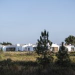 exterior shot over the green landscape up towards craveiral farmhouse in Portugal