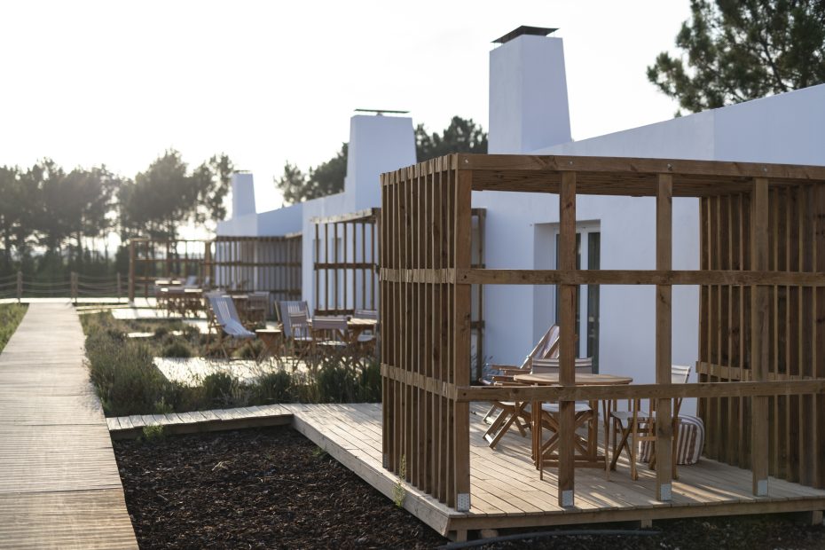 exterior view of rooms and their private decking areas at craveiral farmhouse in portugal