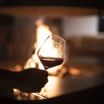 red wine by the open outdoor fire pit at craveiral farmhouse wedding venue in portugal