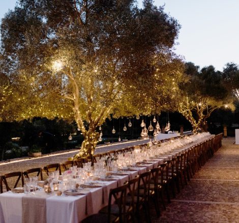 wedding breakfast tables laid up ready for guests at sundown at Son Doblons wedding venue in mallorca spain