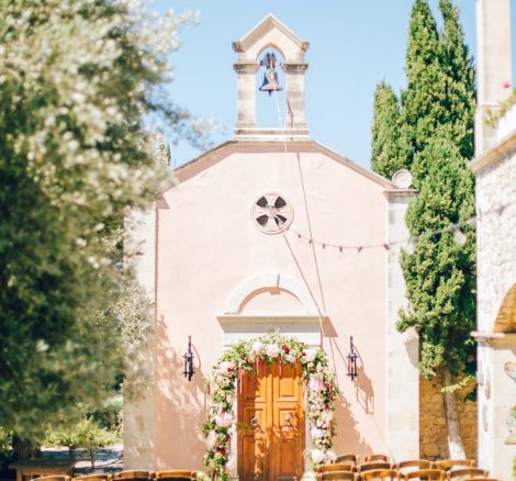 Ceremony venue with decorations and florals ready for a destination wedding in Grecotel Agreco Farm in Crete, Greece, documented by professional wedding photographer.