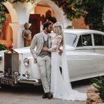 bride and groom next to their wedding car at ibiza wedding venue Hacienda Na Xamena