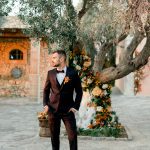 Classy groom posing for a wedding editorial in Grecotel Agreco Farms Crete Greece.