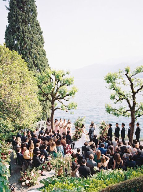 wedding guests at a wedding ceremony overlooking lake como at villa cipressi