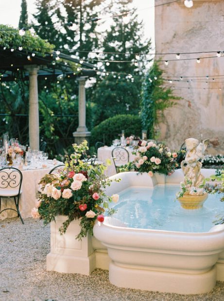 fountain with wedding flower arrangements at villa cipressi Italian wedding venue on lake como