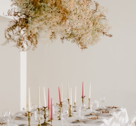 wedding table with candles and dried flowers hanging overhead at wedding venue casa sacoto in portugal