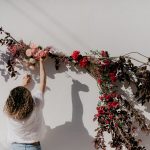 florist hanging a wedding arch at wedding venue casa sacoto in portugal